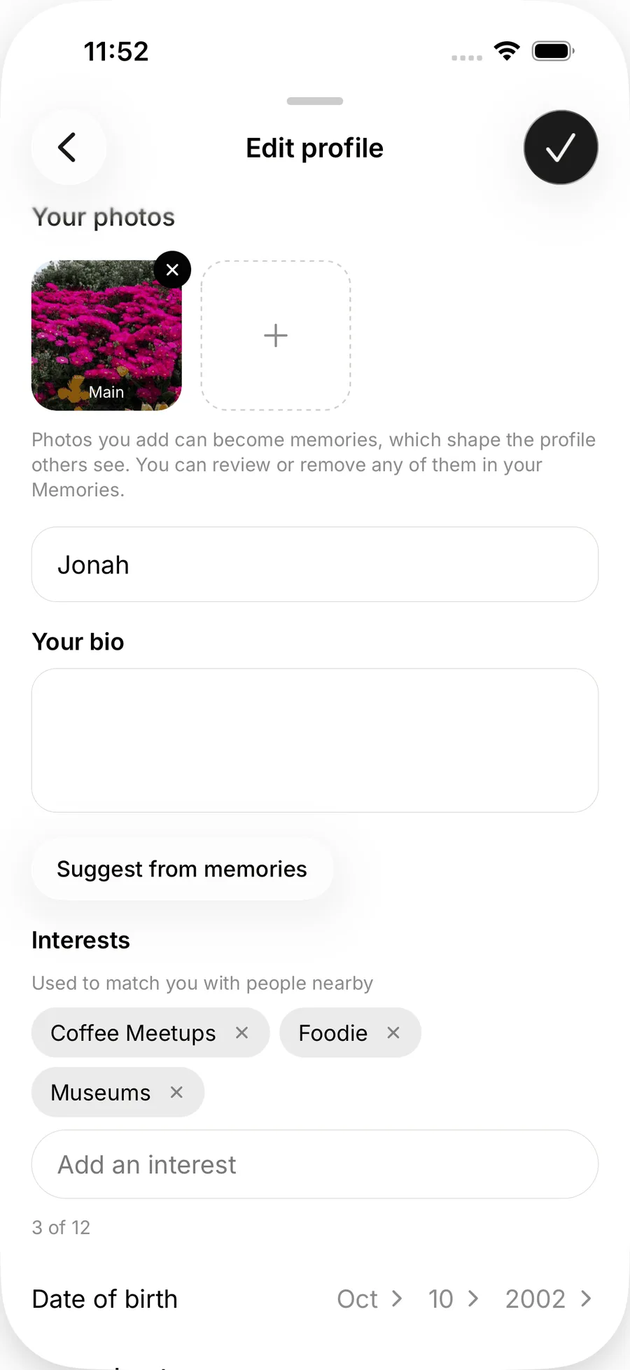 The top of Edit profile on iOS with Your photos, the name field, an empty bio, a Suggest from memories button and interest chips